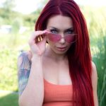Tattooed redhead Korie strolls outdoors with her nipples poking through in “Let The Good Times Roll” by Suicide Girls_6858d940b6781.jpeg